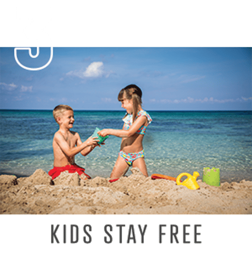 boy and girl playing in sand enjoying free stay boy and girl playing in sand enjoying free stay